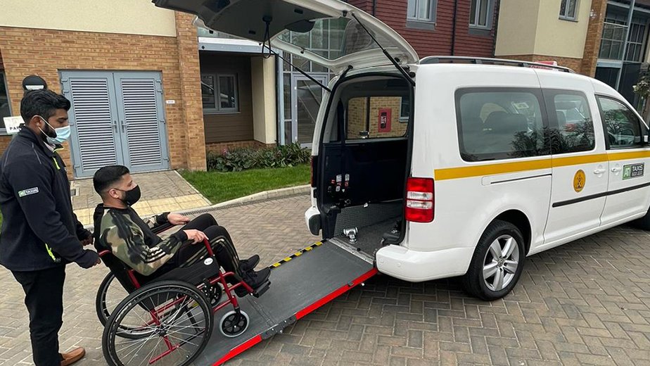 Private chauffeur opening door for beautiful female passenger, car services